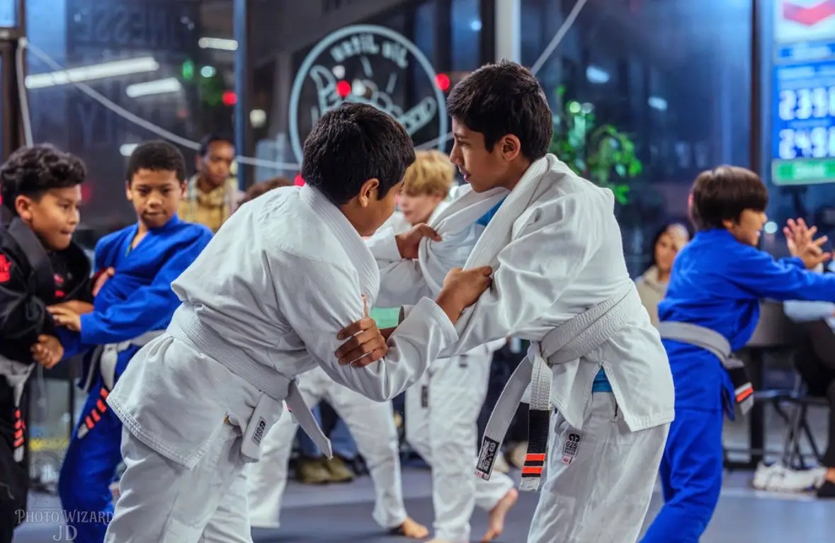 Kids practicing standing grappling in pairs