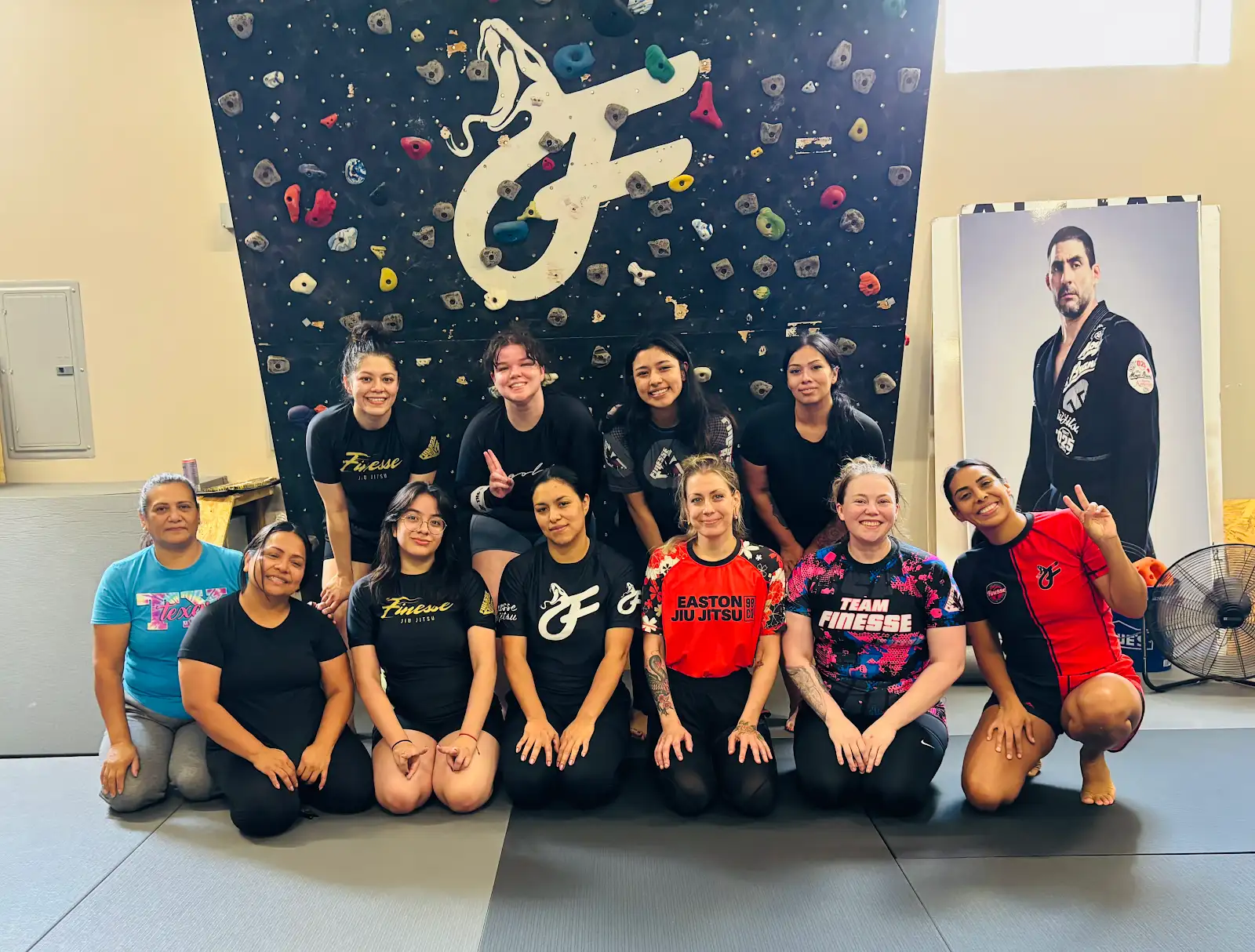 Women from the Finesse community together on the mats